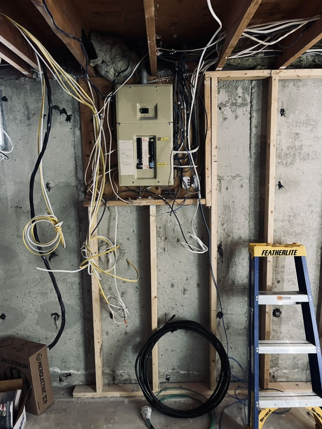 Basement electrical panel and wiring during framing, before drywall