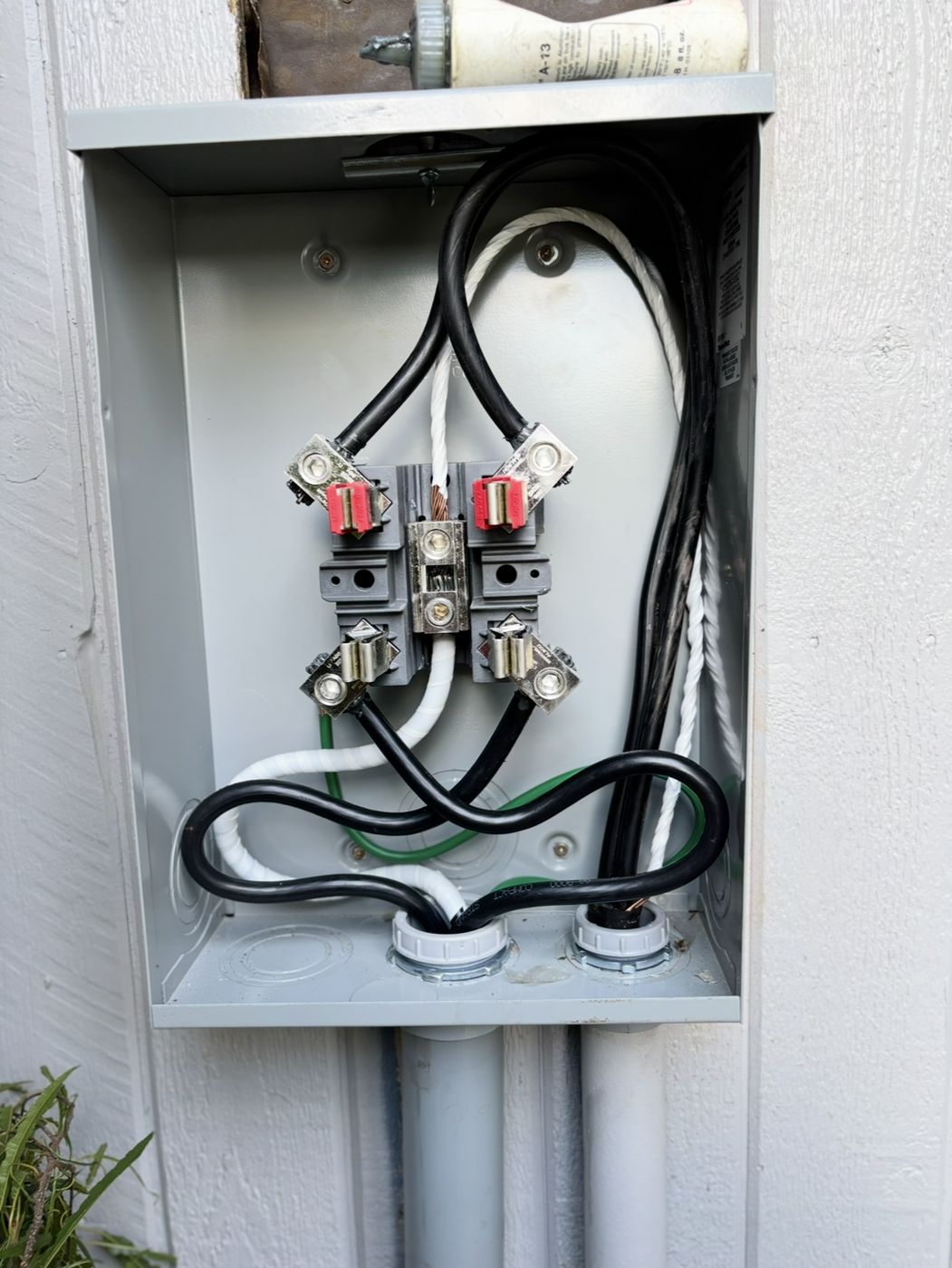 Meter base with service conductors entering through underground conduit