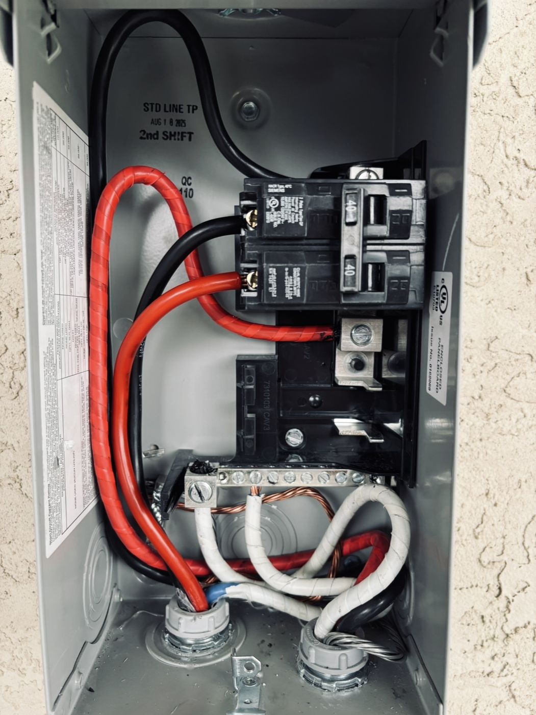 Exterior sub panel with 40 amp two-pole breakers and neatly routed conductors